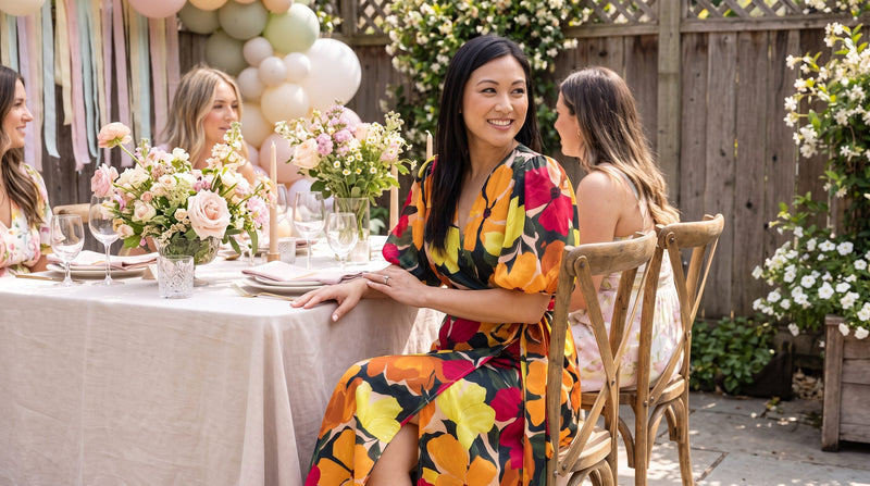 Guest in a floral bubble-sleeve wrap midi dress seated at a garden brunch, a dressy-casual bridal shower look.