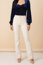 Front view of the Heart of Glass navy velvet sweetheart top worn by our model.