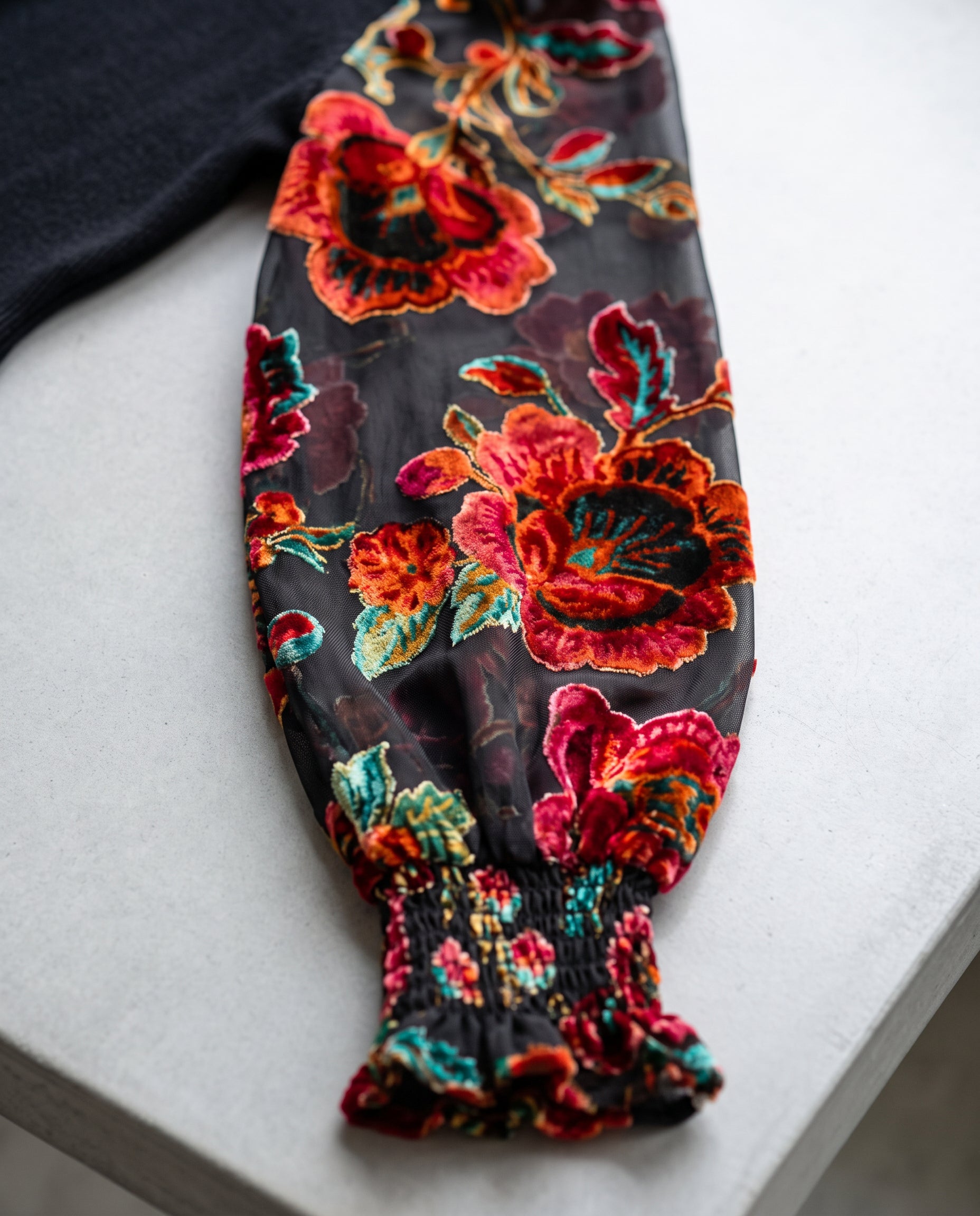 Close detail of the floral sheer sleeve and gathered cuff on You're My Favorite Sweater Dress.
