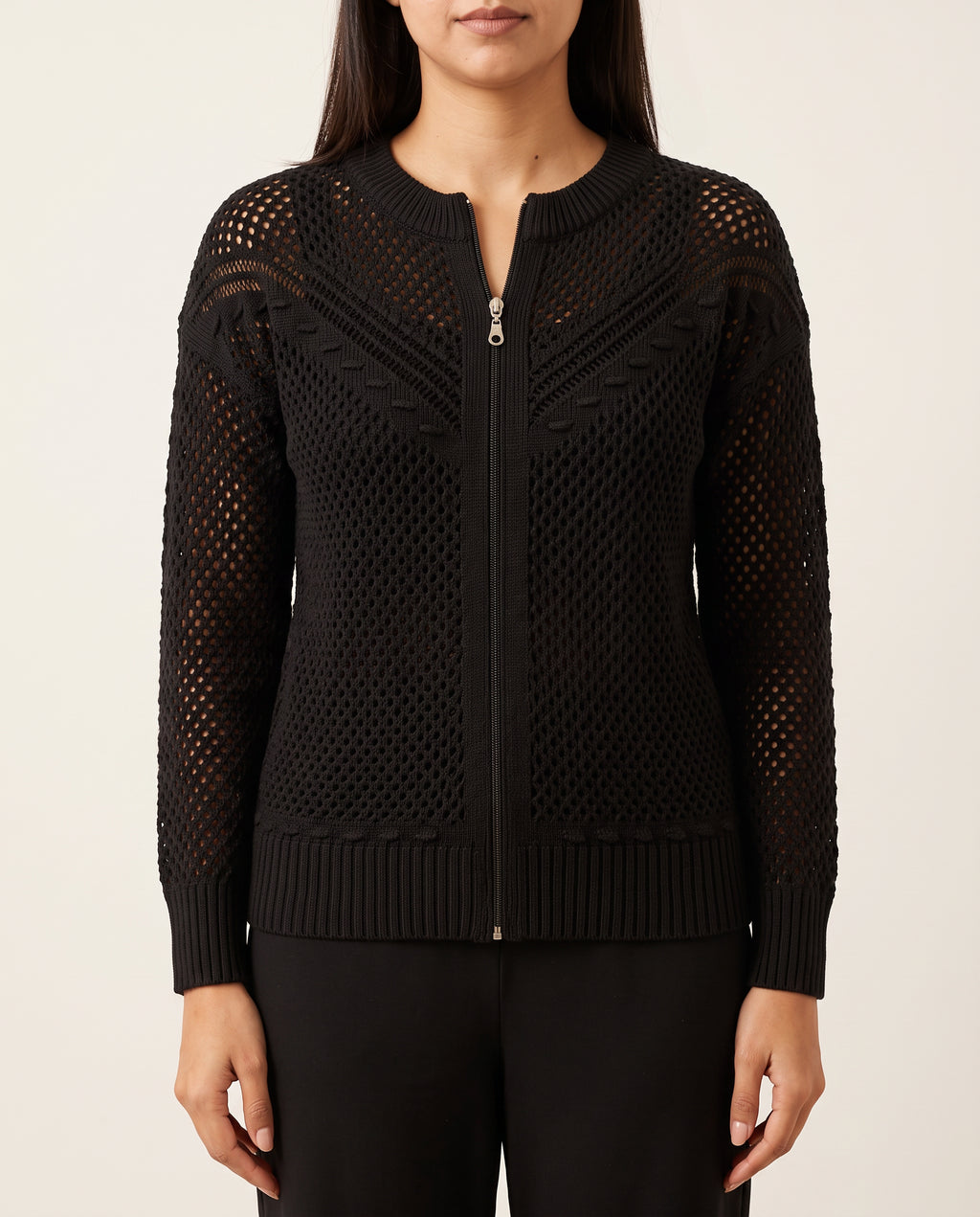 Close view of the black crochet hoodie showing the zipper, open knit and ribbed hem