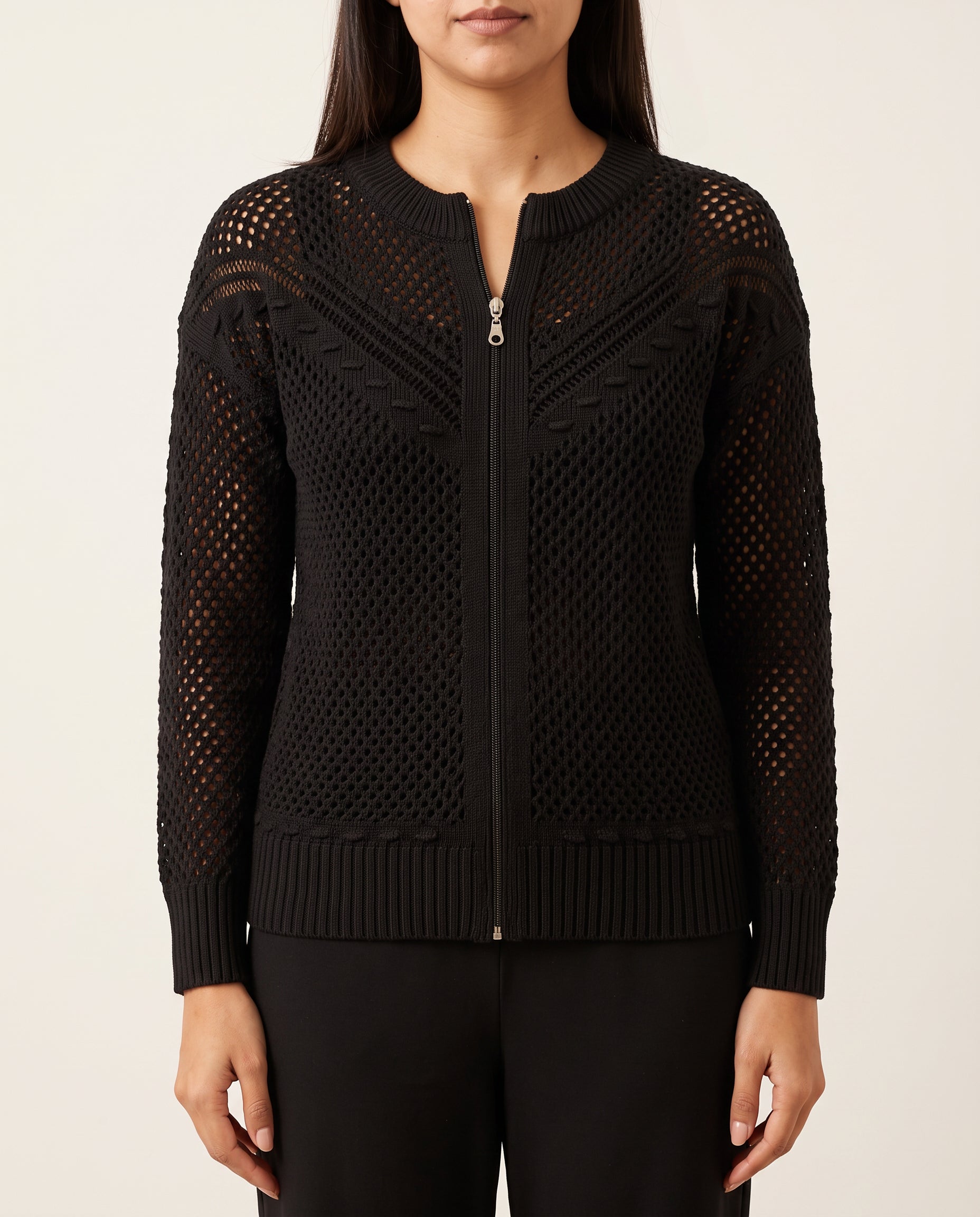 Close view of the black crochet hoodie showing the zipper, open knit and ribbed hem