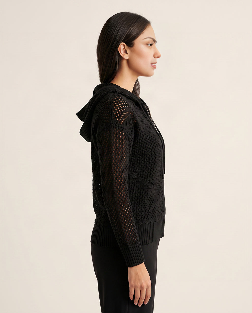 Side view of the Got My Reasons black crochet zip hoodie showing its hip-length fit