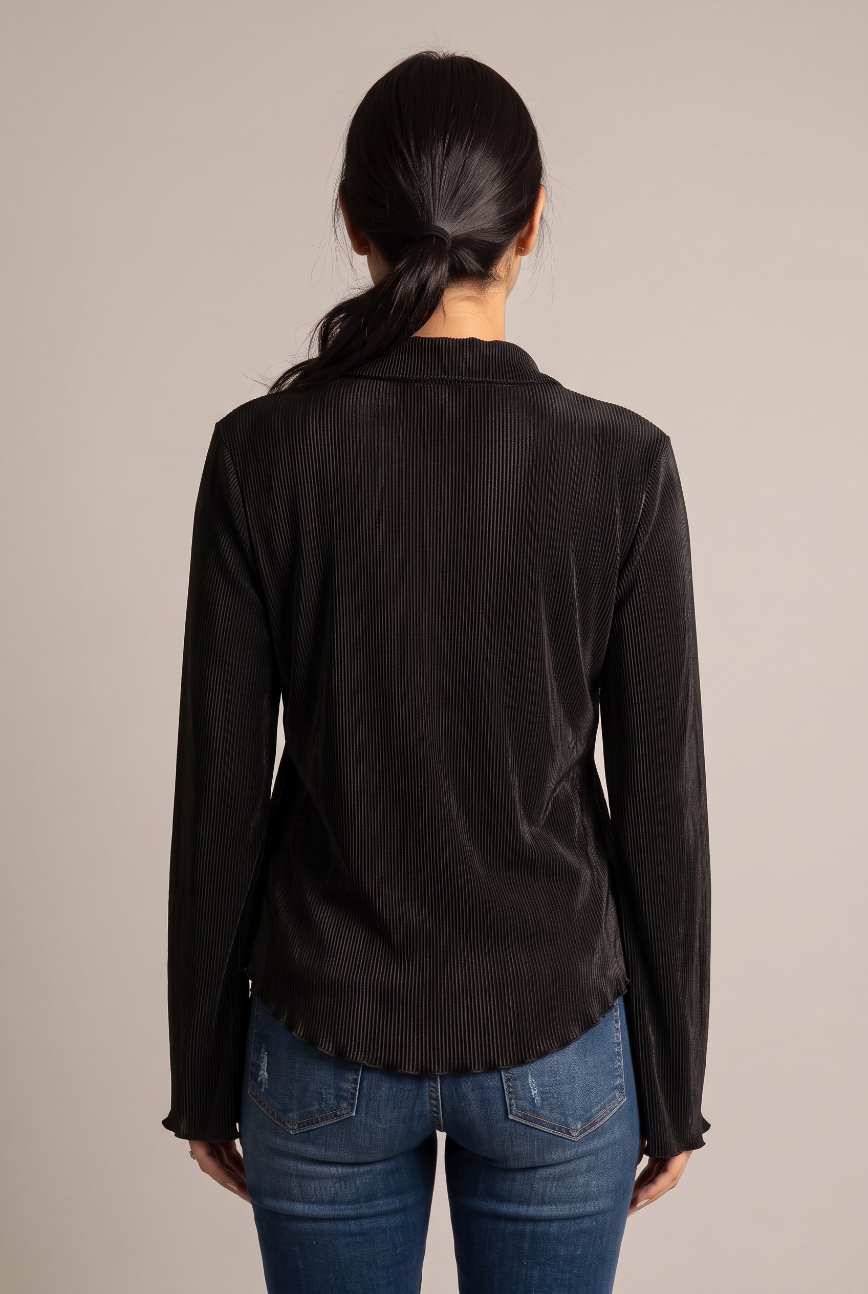 Back view of the Large Champagne pleated top showing its straight back and softly waved hem.