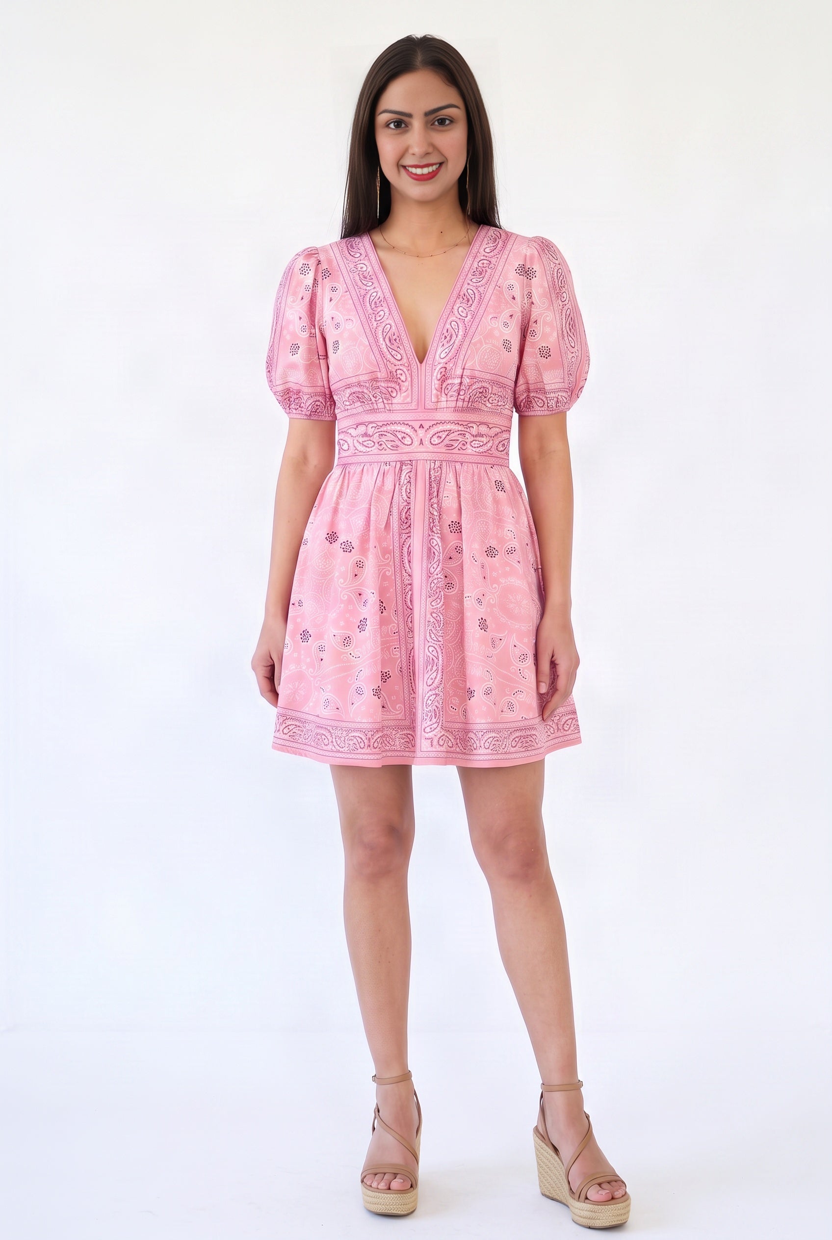 Shweta wearing the Forget Me Not Paisley Dress, showing its pink mini silhouette and paisley print.