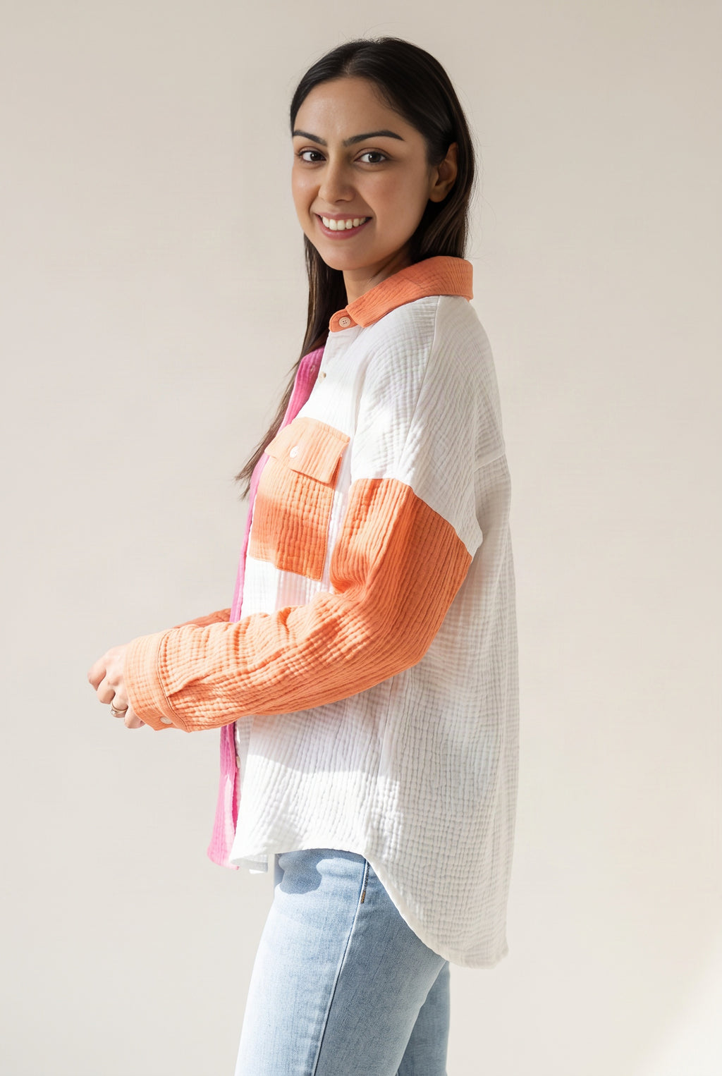 Side view of the Pink Just Chilling shirt showing its loose volume and curved shirttail hem.