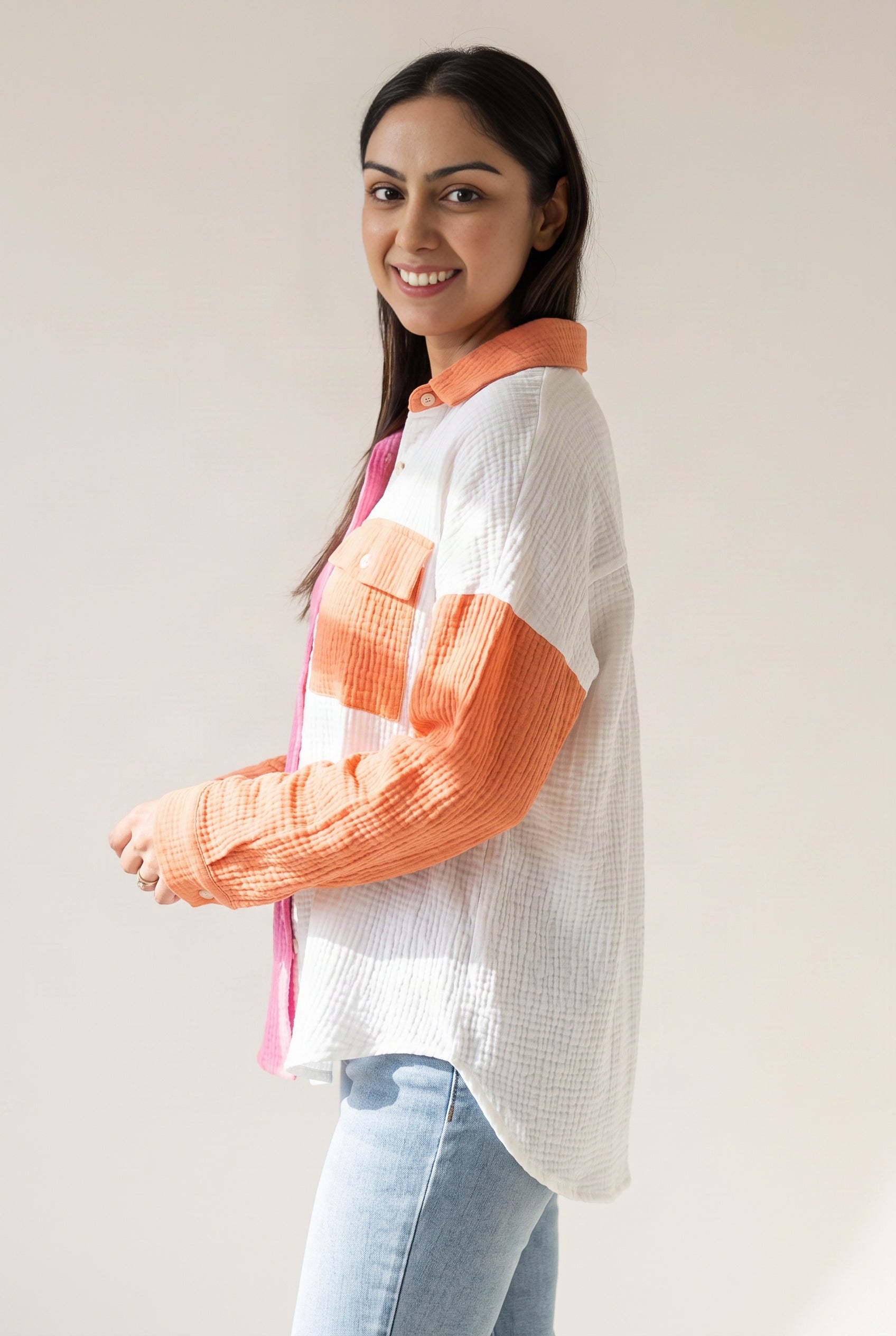 Side view of the Pink Just Chilling shirt showing its loose volume and curved shirttail hem.