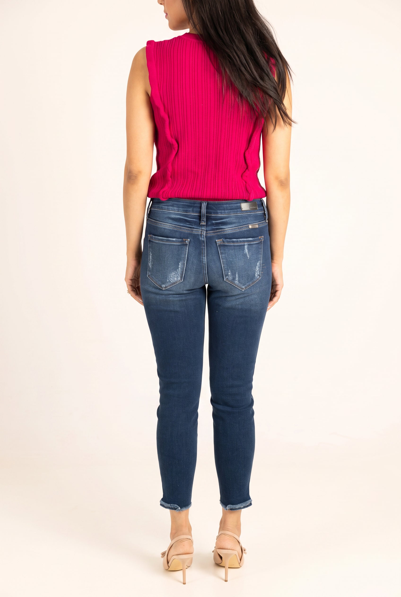 Back view of Beautiful Day Mid Rise Ankle Jeans showing the seat fit, patch pockets and raw hems.