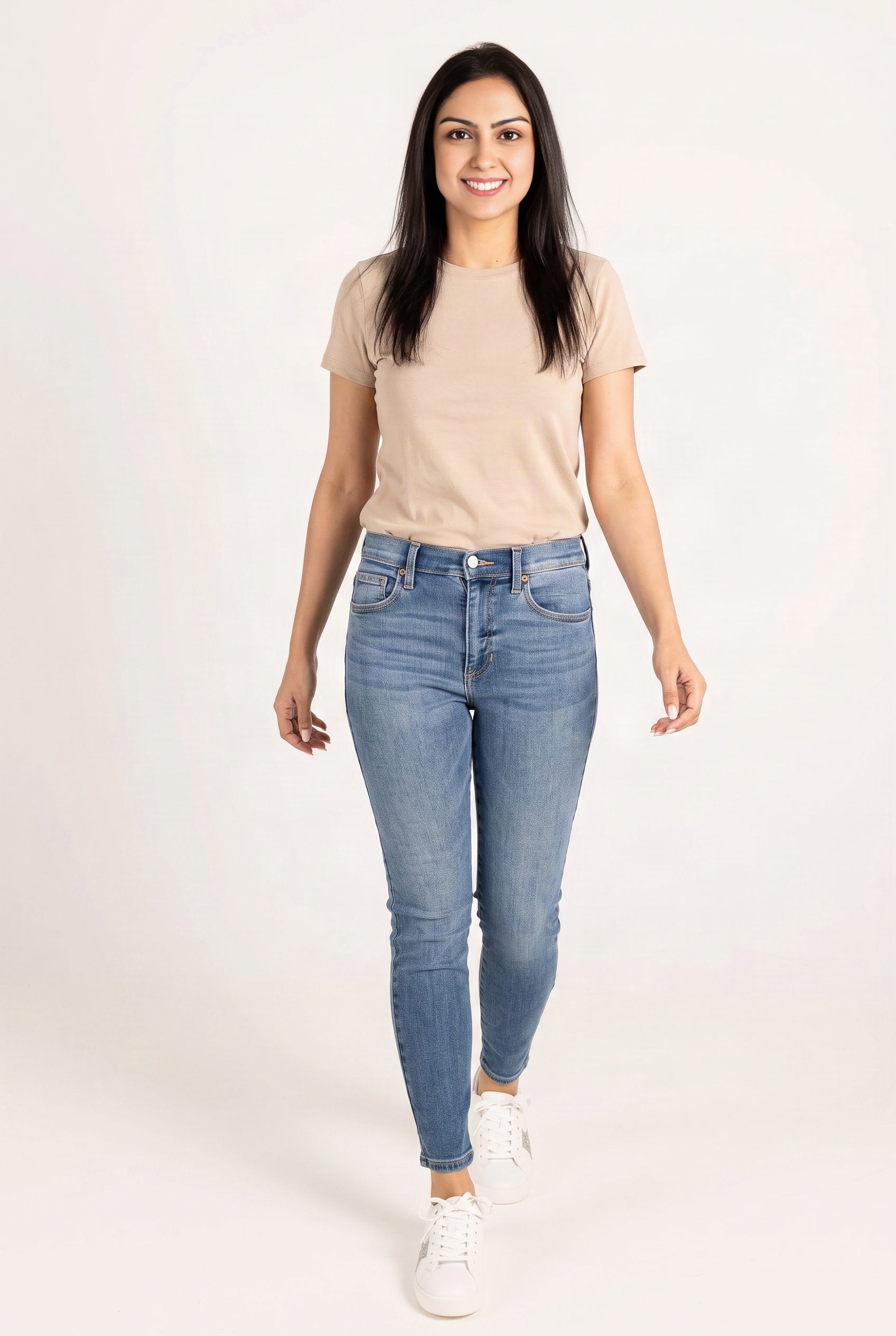 Shweta walking in Bold Adventures skinny jeans, showing the fitted legs and ankle-skimming hems.