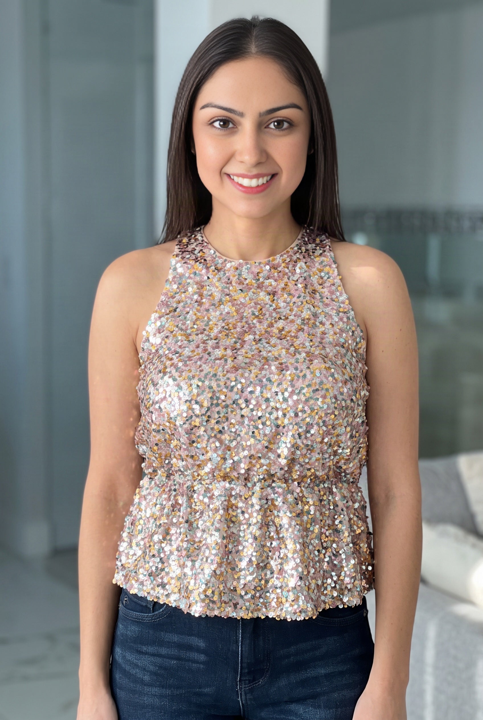 Multicolor sequin surface and halter neckline of the Last Night Sequin Halter Top on Shweta.