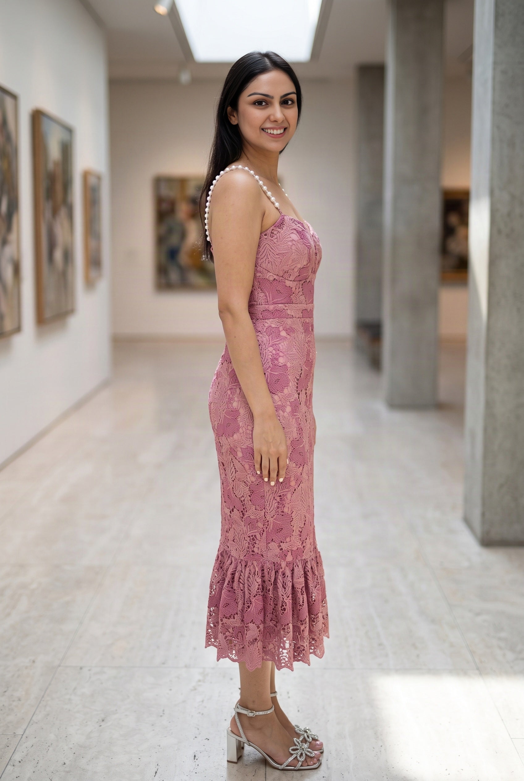 Side view of the Medium pink lace mermaid dress showing its fitted shape and knee flounce.