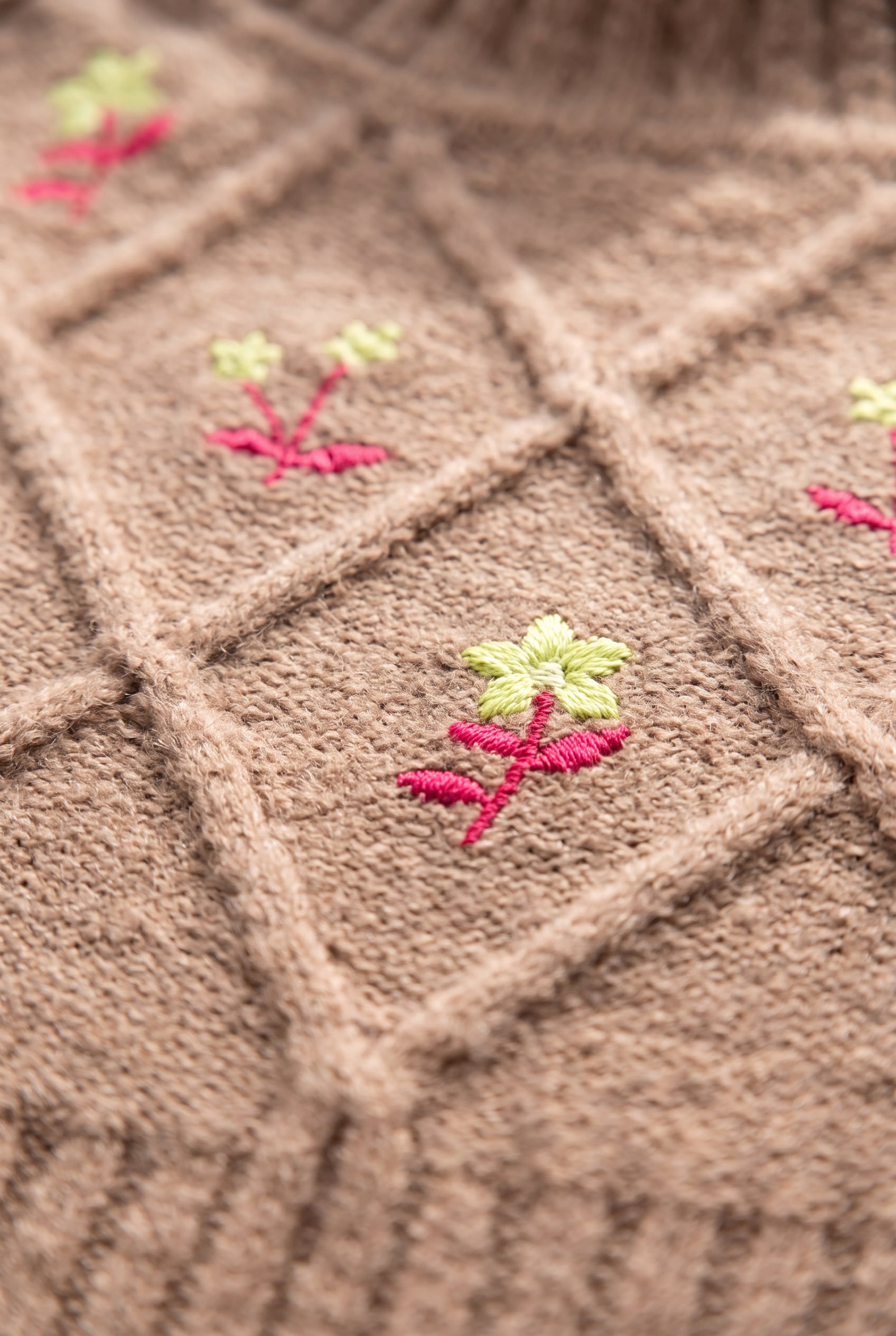 Cable-knit diamond and pink floral embroidery detail on the Happy Times Floral Sweater.