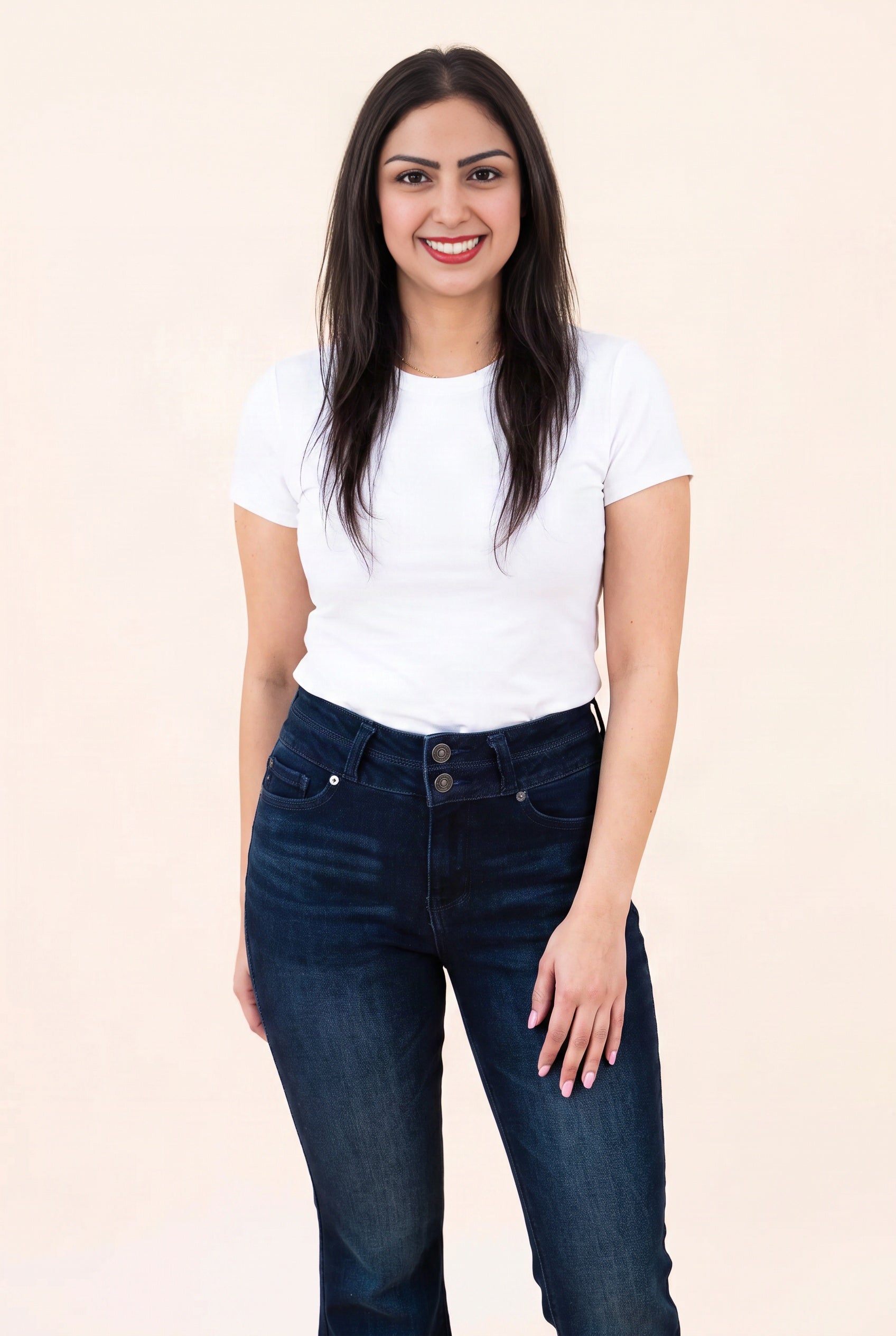 High-rise waistband of the Always on My Mind jeans showing two buttons, belt loops, pockets and dark wash.