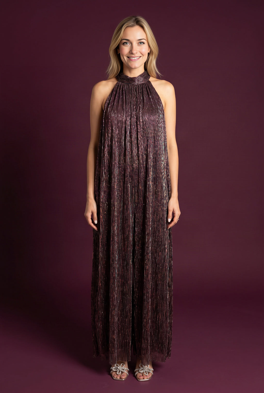 Elsa wearing the All That She Wants Jumpsuit, showing its halter neck and full wide-leg silhouette.