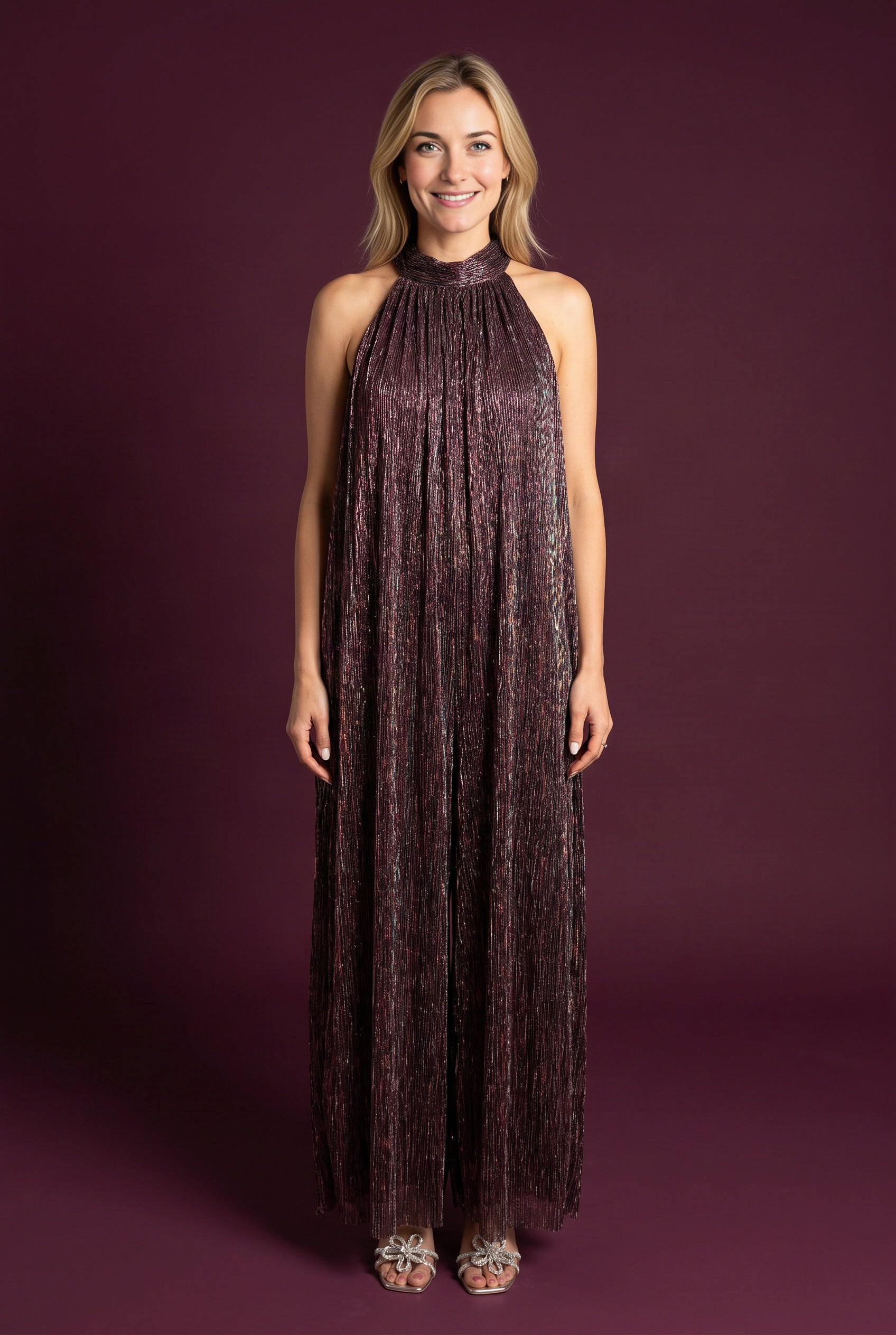 Elsa wearing the All That She Wants Jumpsuit, showing its halter neck and full wide-leg silhouette.