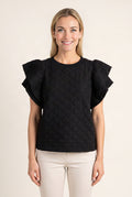See You Tonight black ruffle sleeve top worn untucked, showing its full front length and loose fit.