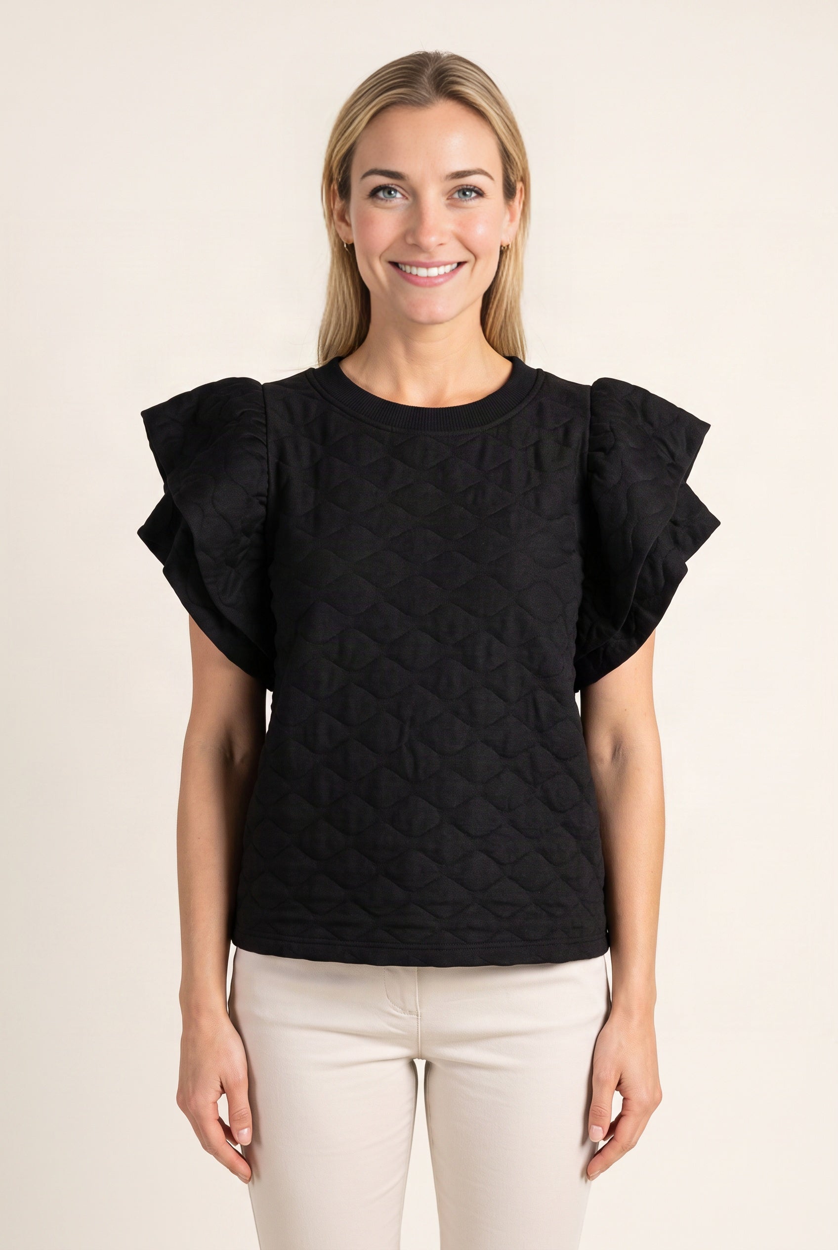 See You Tonight black ruffle sleeve top worn untucked, showing its full front length and loose fit.