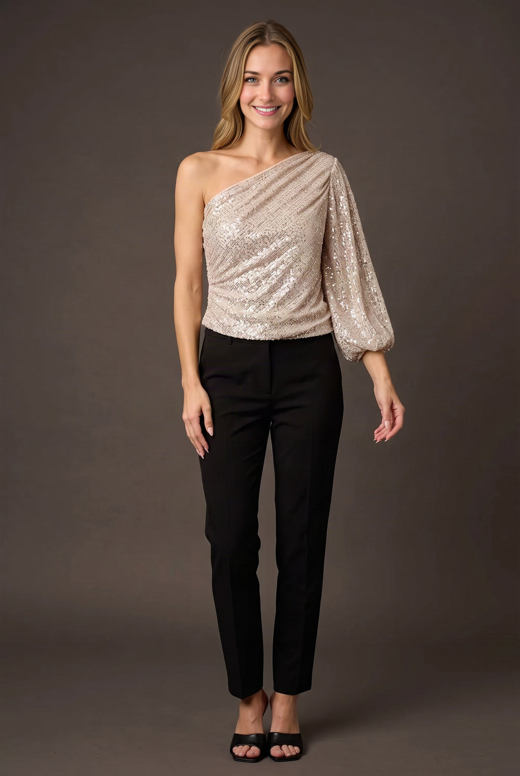 Elsa wearing the champagne one-shoulder sequin top straight-on with its full blouson fit visible.