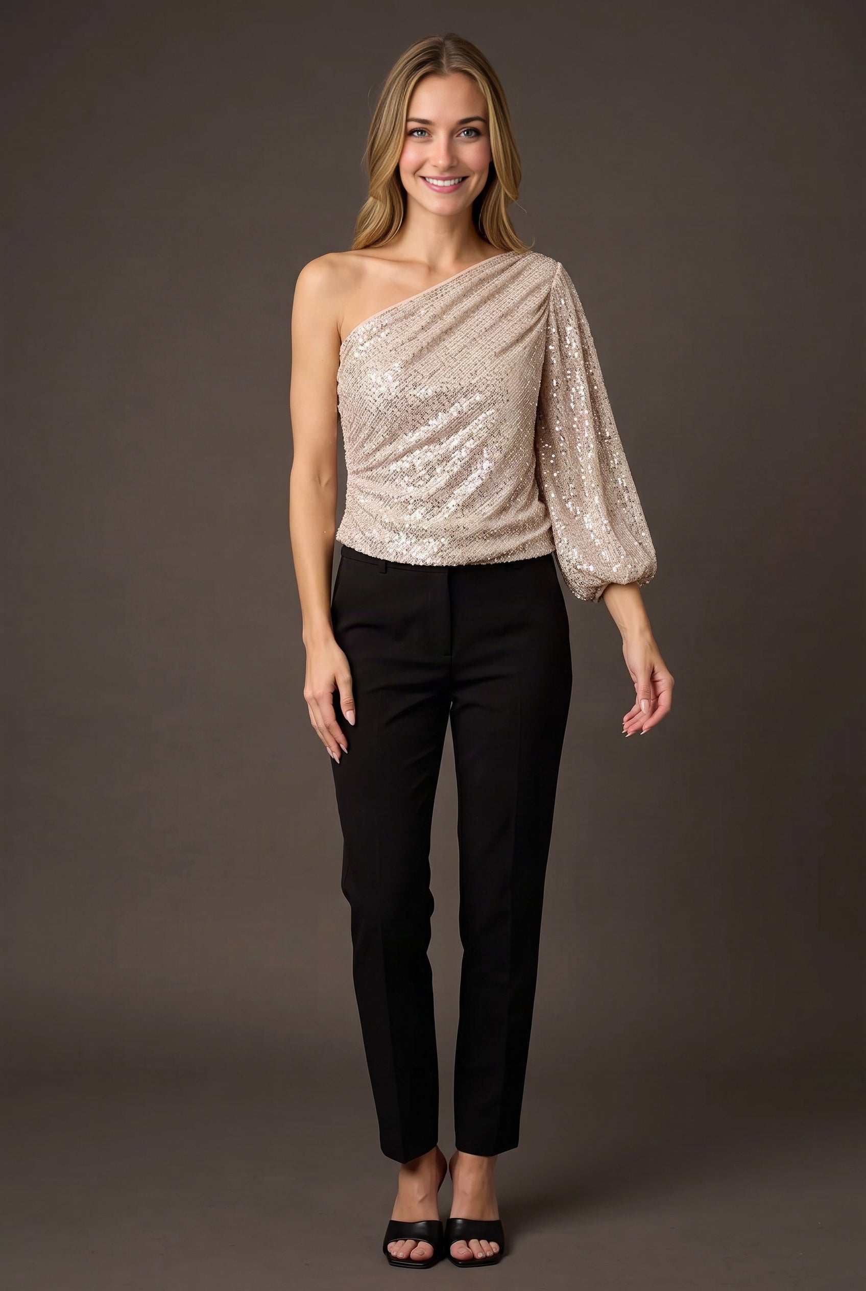 Elsa wearing the champagne one-shoulder sequin top straight-on with its full blouson fit visible.