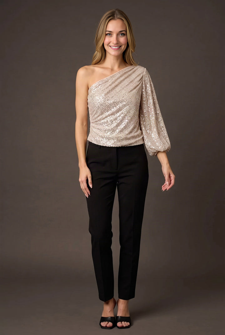 Elsa wearing the champagne one-shoulder sequin top straight-on with its full blouson fit visible.