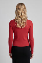 Back view of the red I Don't Care Cardigan Sweater showing its fitted shape and hem.