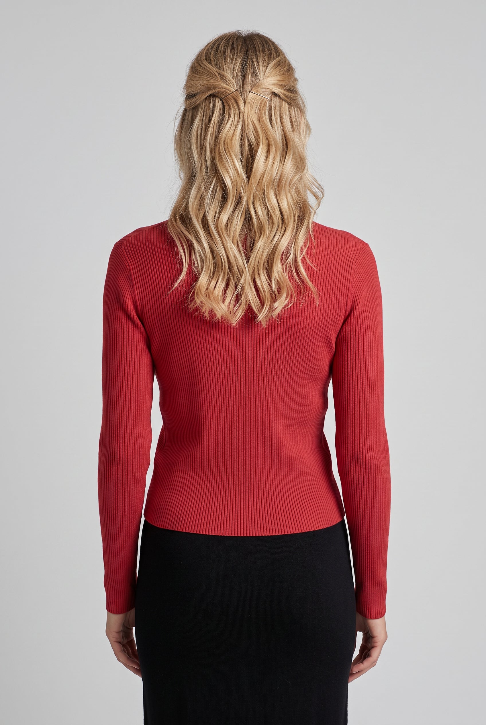 Back view of the red I Don't Care Cardigan Sweater showing its fitted shape and hem.