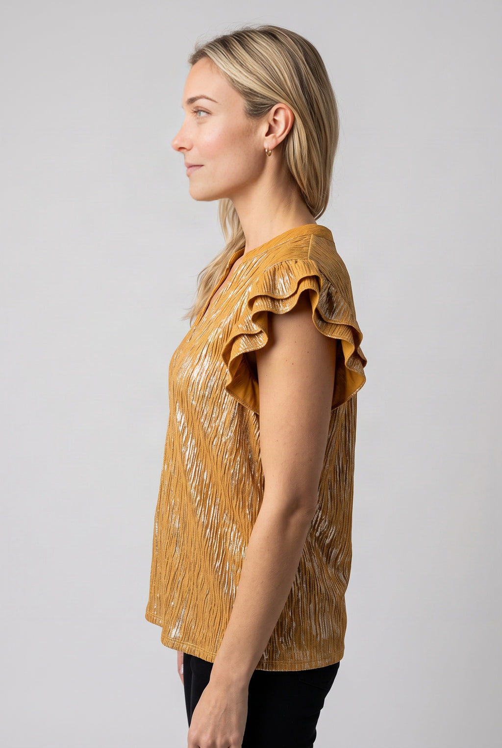 Straight side fit of the Mustard ruffle top showing its armhole, sleeve projection and hem length.