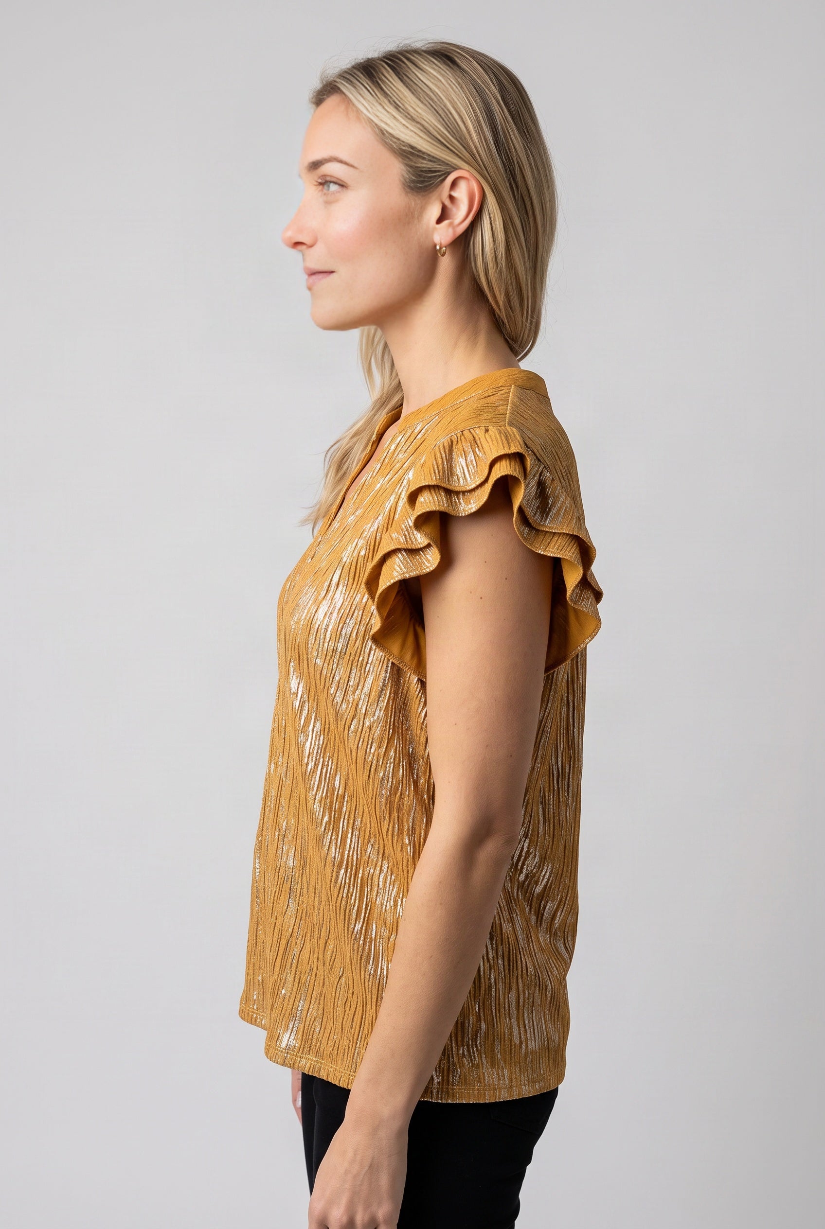 Straight side fit of the Mustard ruffle top showing its armhole, sleeve projection and hem length.