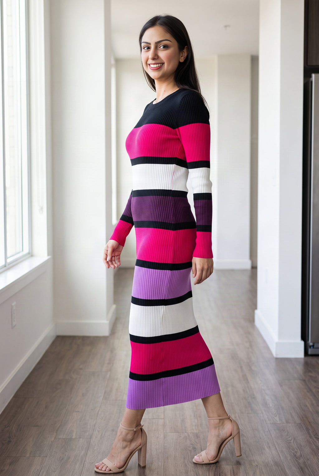 Side view of the color block sweater dress showing its close fit, long sleeve and near-ankle hem.