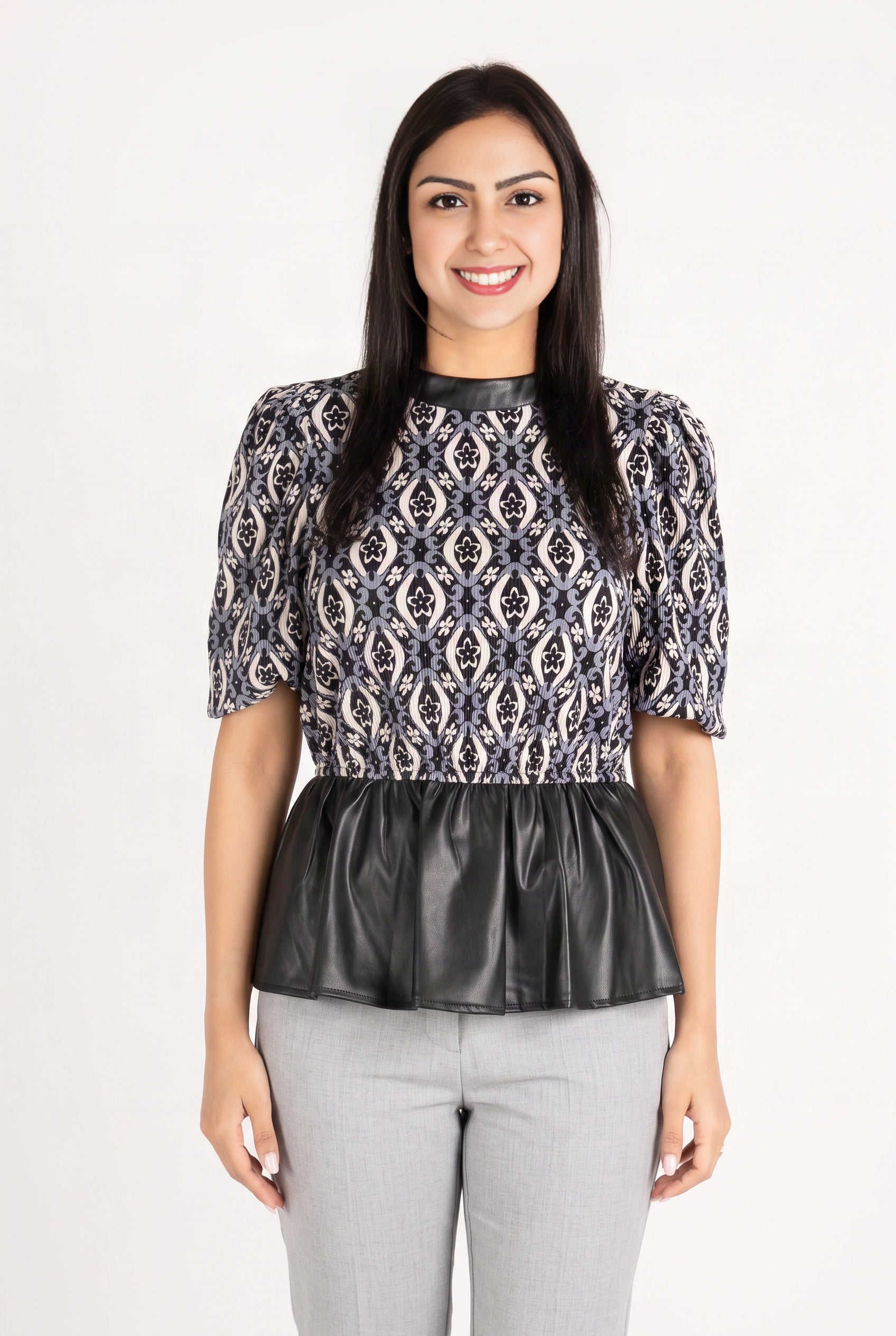 Last Night peplum top in size Medium on Shweta, showing the clean front fit and waist-defining flare.