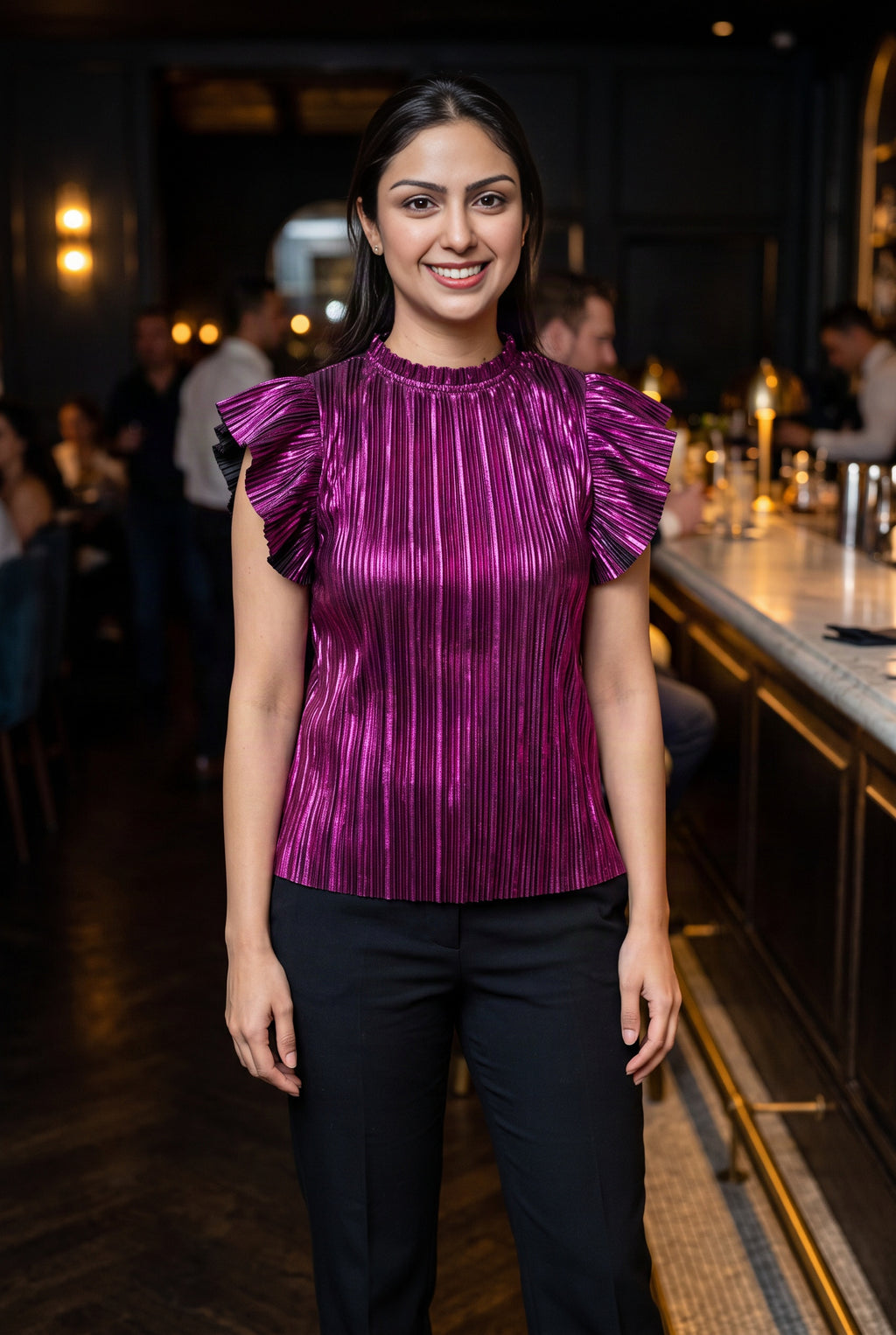 Metallic purple ruffle sleeve top styled with black trousers for an evening out.