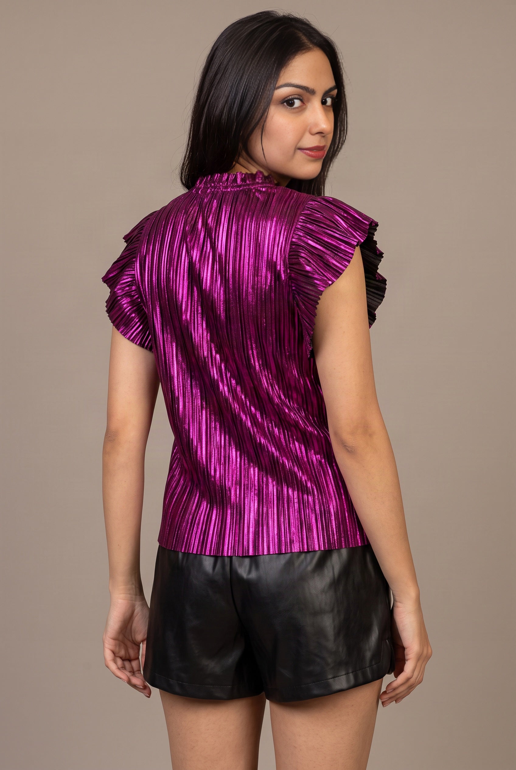 Back of the metallic purple ruffle sleeve top showing the collar, pleats and black sleeve accents.