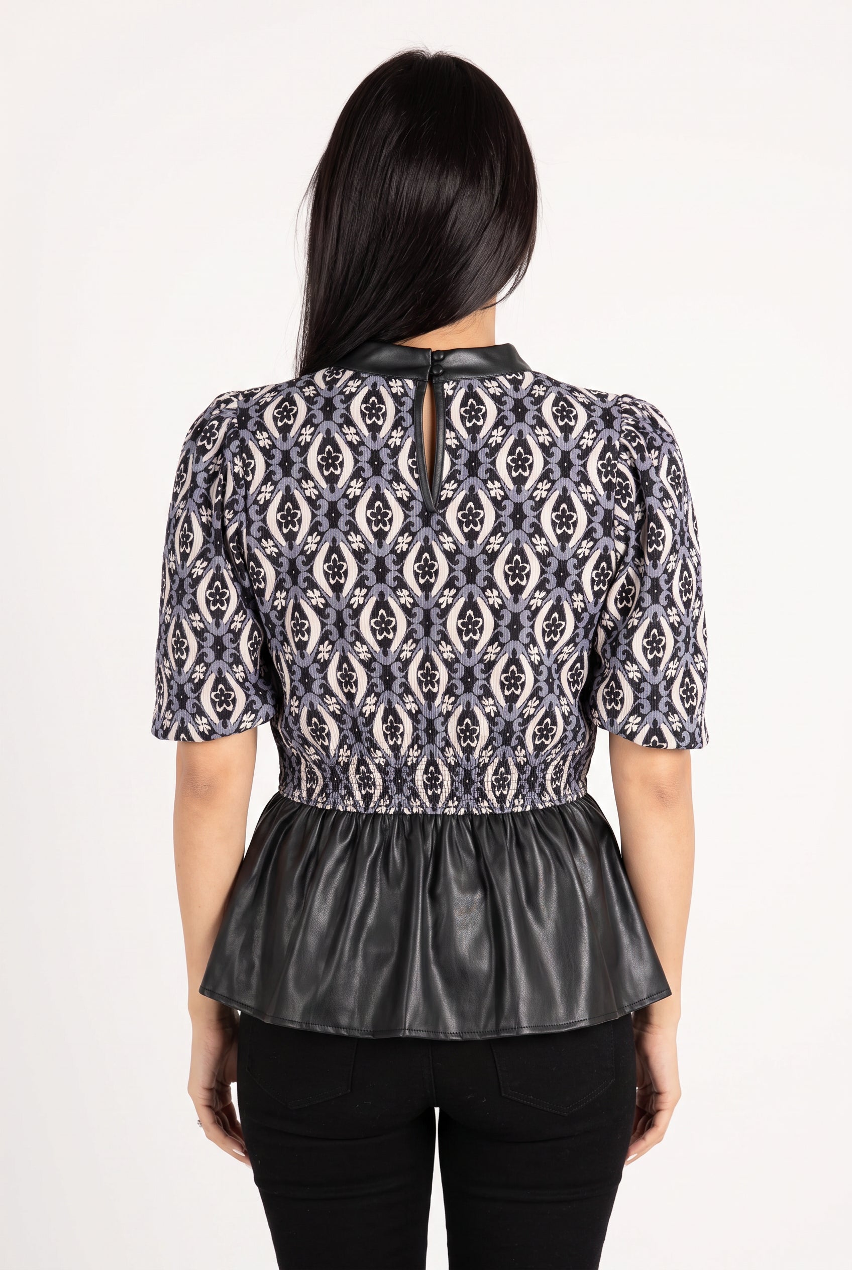 Best-guess back view of the Last Night peplum top showing the rear neckline and faux-leather peplum.