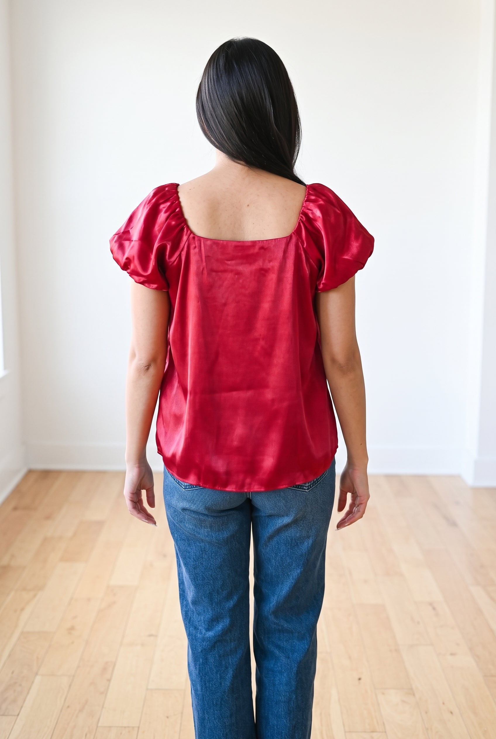 Back fit of the red Until I Found Her satin top showing the square neckline and loose hip-length hem.