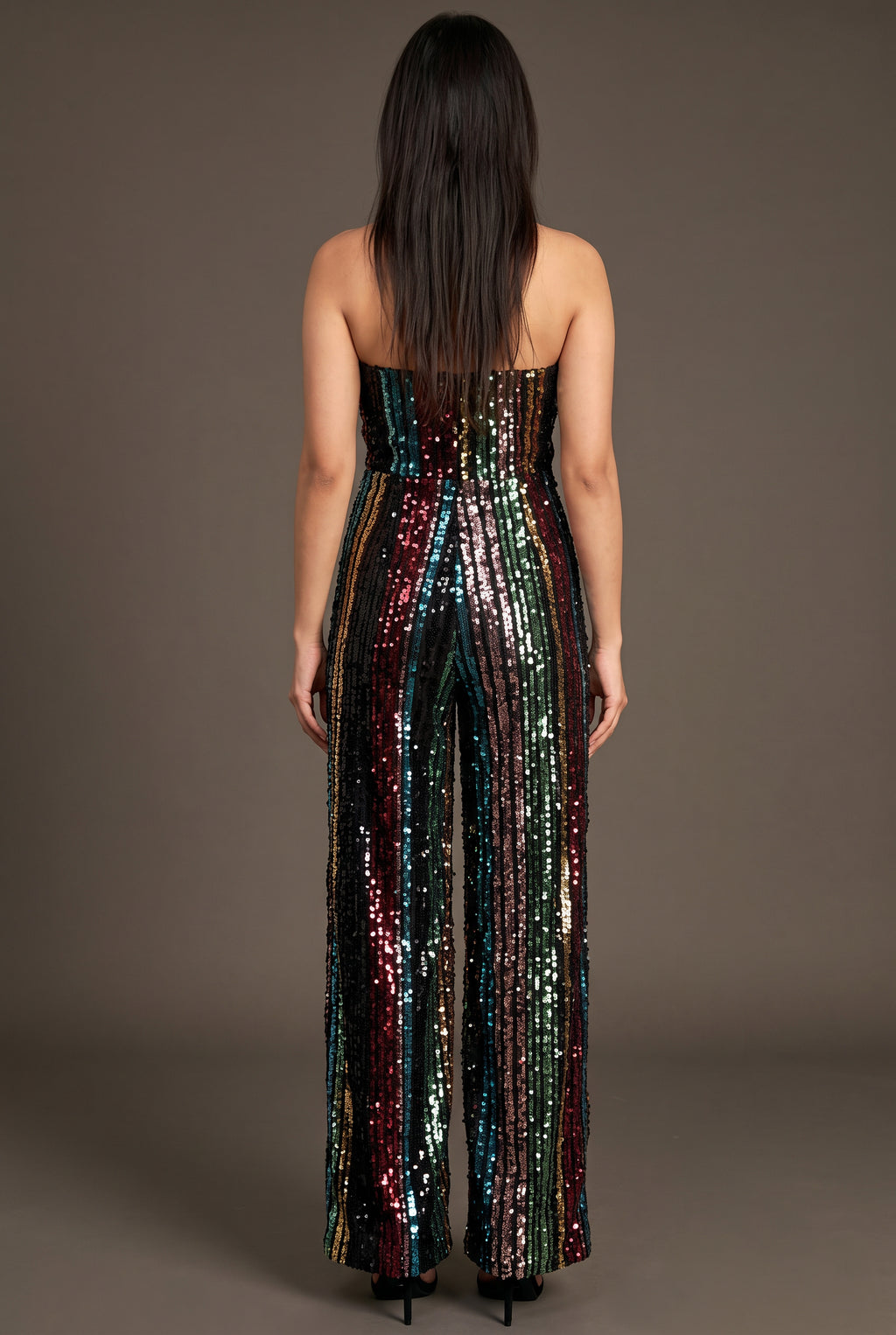 Back fit of the jumpsuit showing its straight strapless back and continuous sequin stripes.