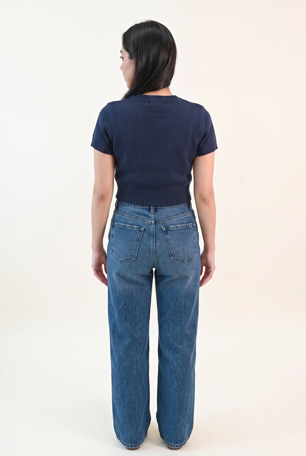 Back fit of the navy teddy bear sweater top showing its plain back and cropped hem.