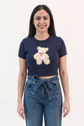 Front fit of the navy Melting My Heart teddy bear sweater top with mid-rise denim.