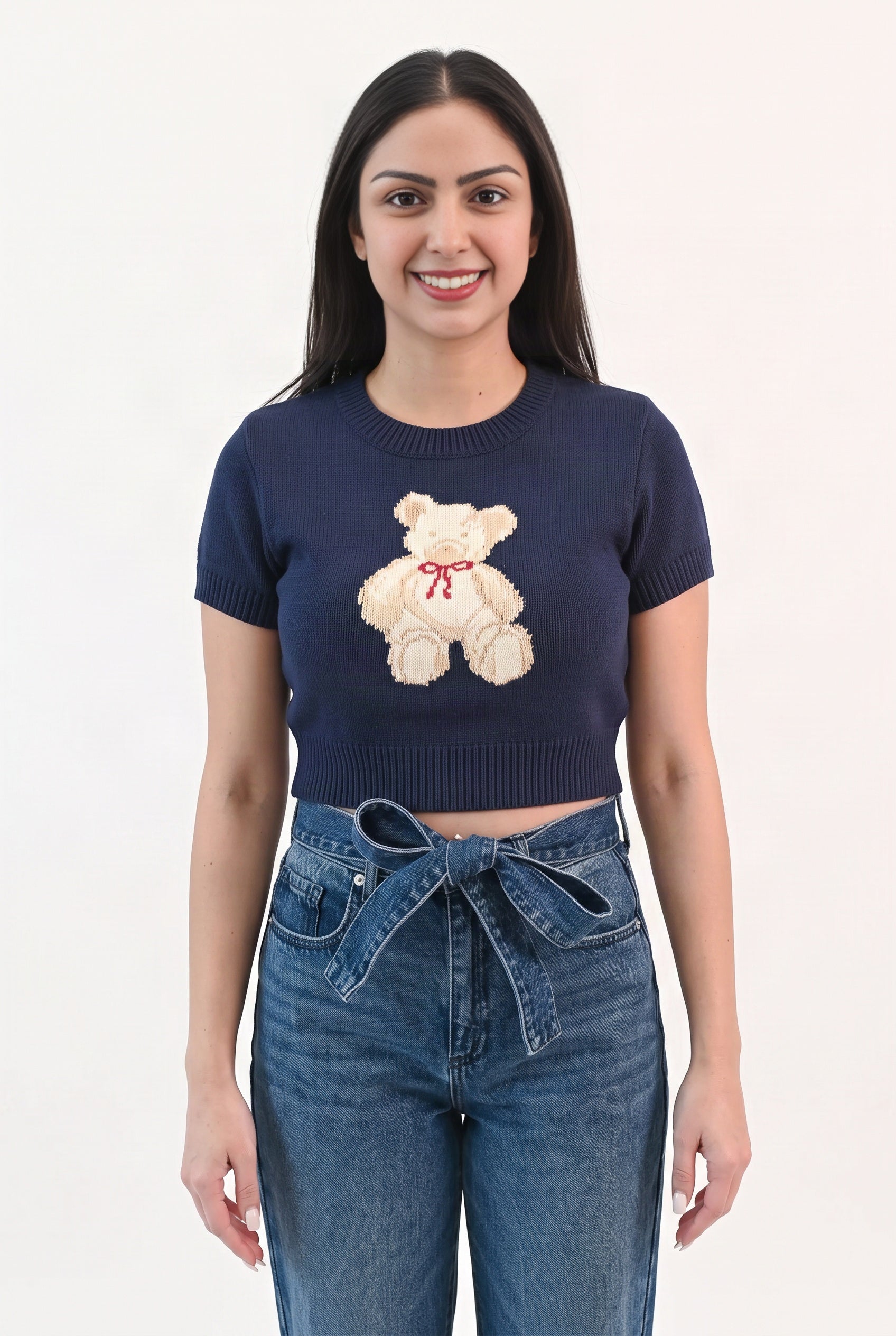 Front fit of the navy Melting My Heart teddy bear sweater top with mid-rise denim.