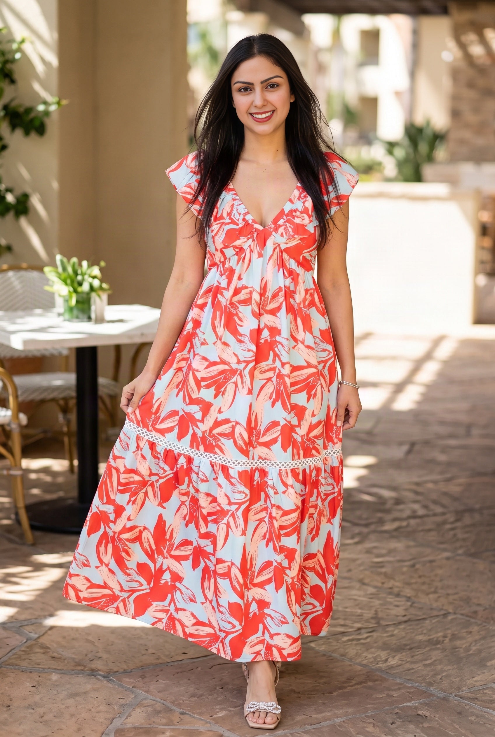 Shweta wears the Painted The Sky Floral Maxi Dress at a vacation brunch, showing its flowing skirt in daylight.