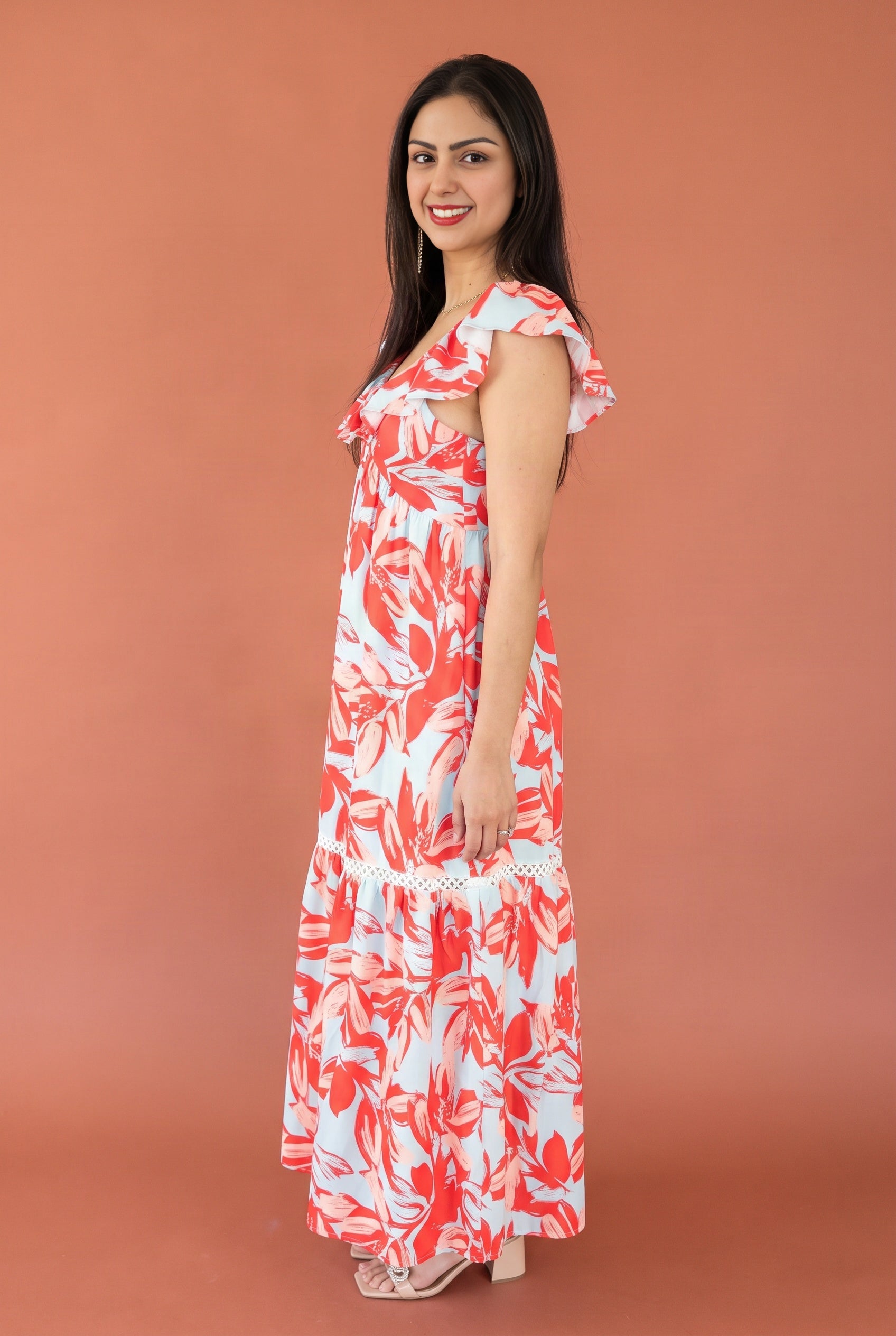 Side view of the Painted The Sky Floral Maxi Dress showing the flutter sleeve, open armhole and flowing fit.