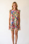 Elsa wearing the Keep Blooming floral mini dress, showing its loose A-line fit and above-knee length.