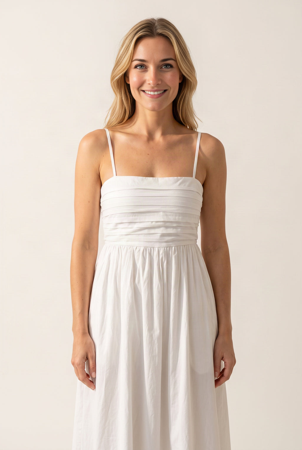 Love Actually White Pleated Midi Dress close view of its square neckline, straps and tucked bodice.