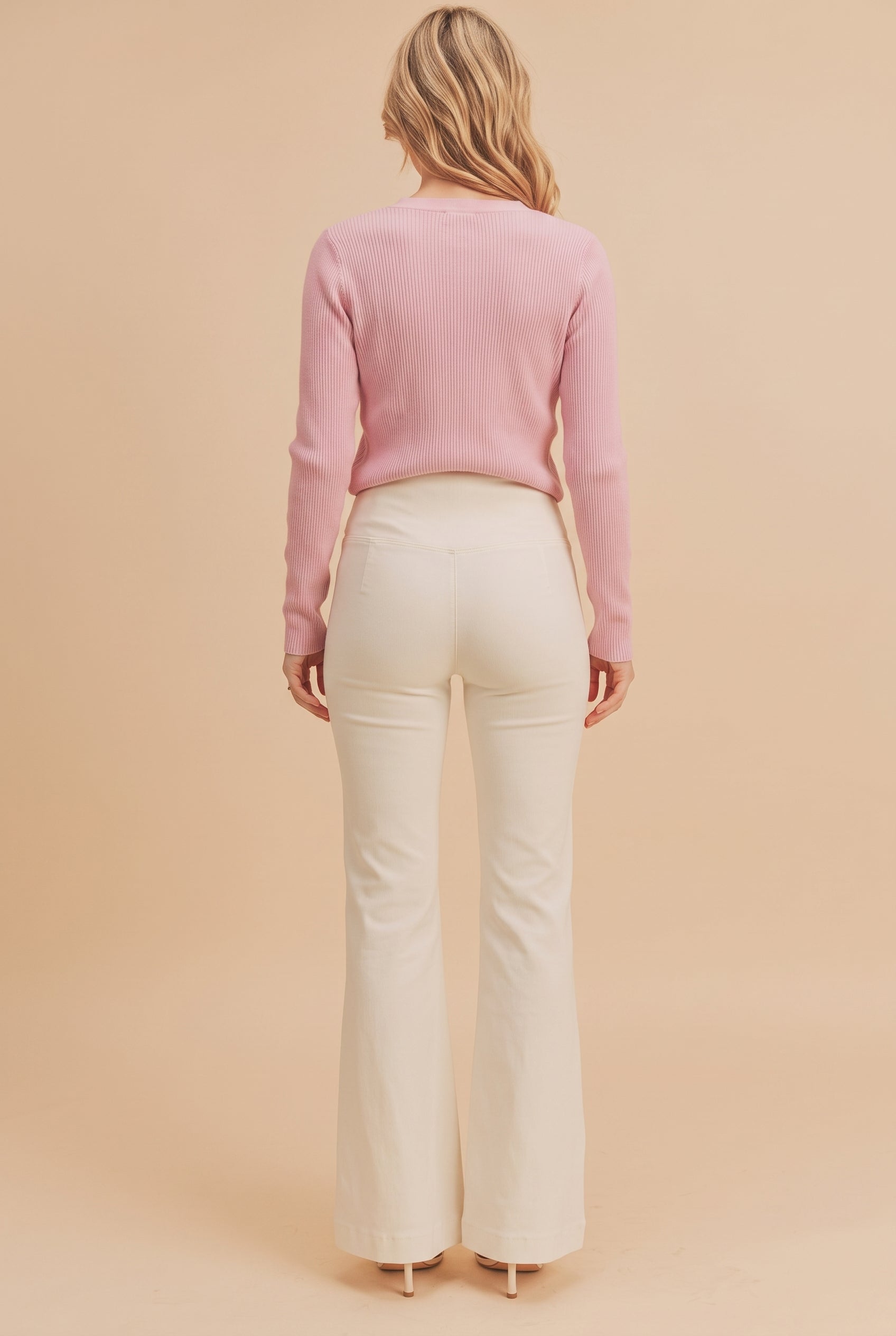 Rear view of Just The Beginning Flare Jeans showing the plain pocketless seat and center-back seam.