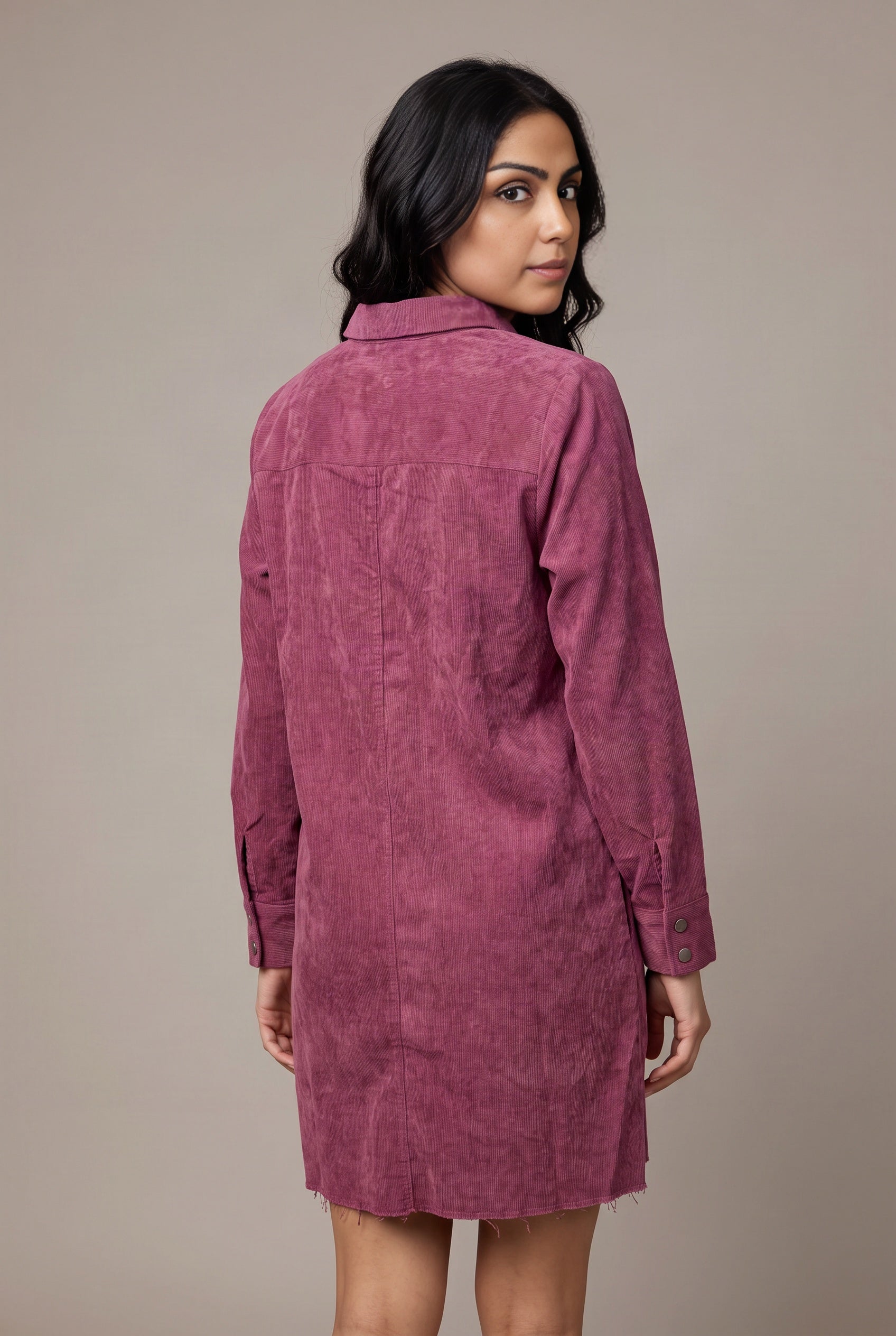 Back view of the Small mauve corduroy shirt dress showing the shoulder yoke and raw mini hem.
