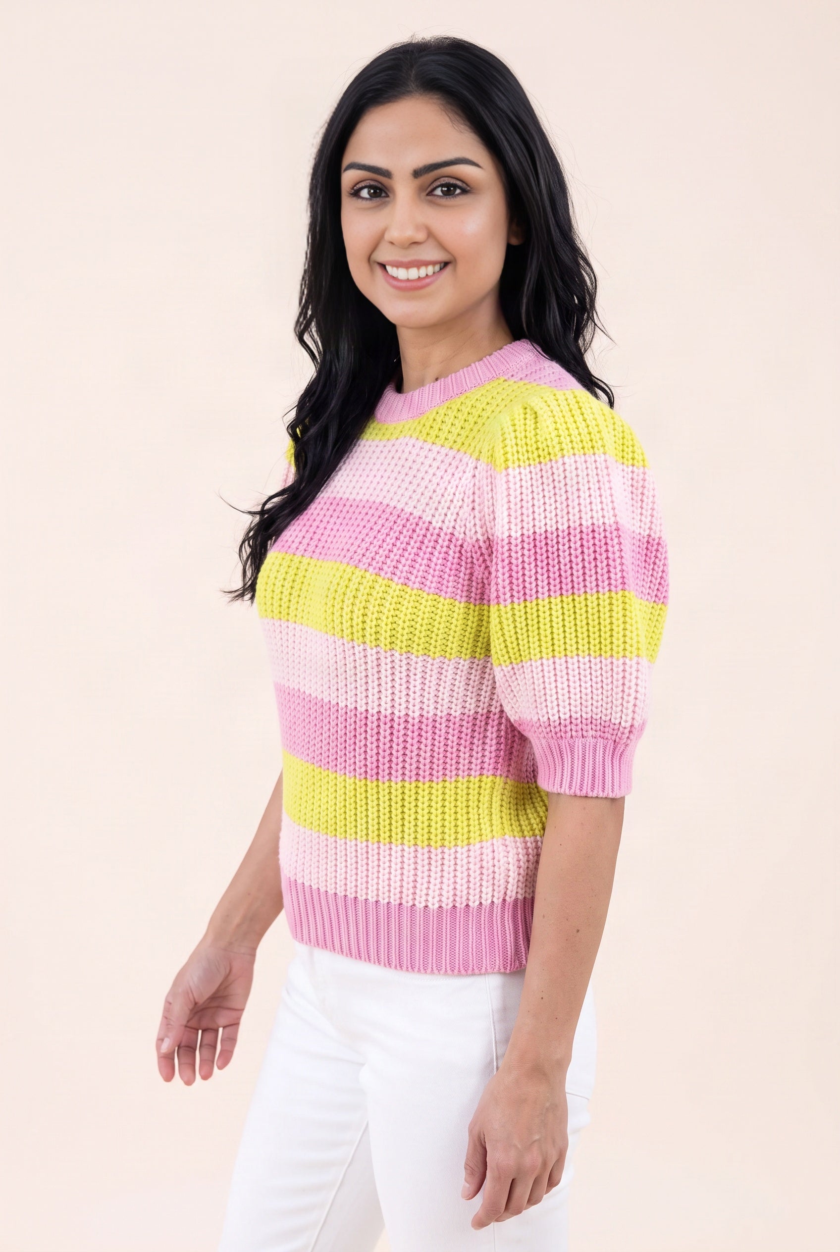 Angled side fit of the Share Your Story Sweater Top showing its raised puff sleeve and high-hip hem.