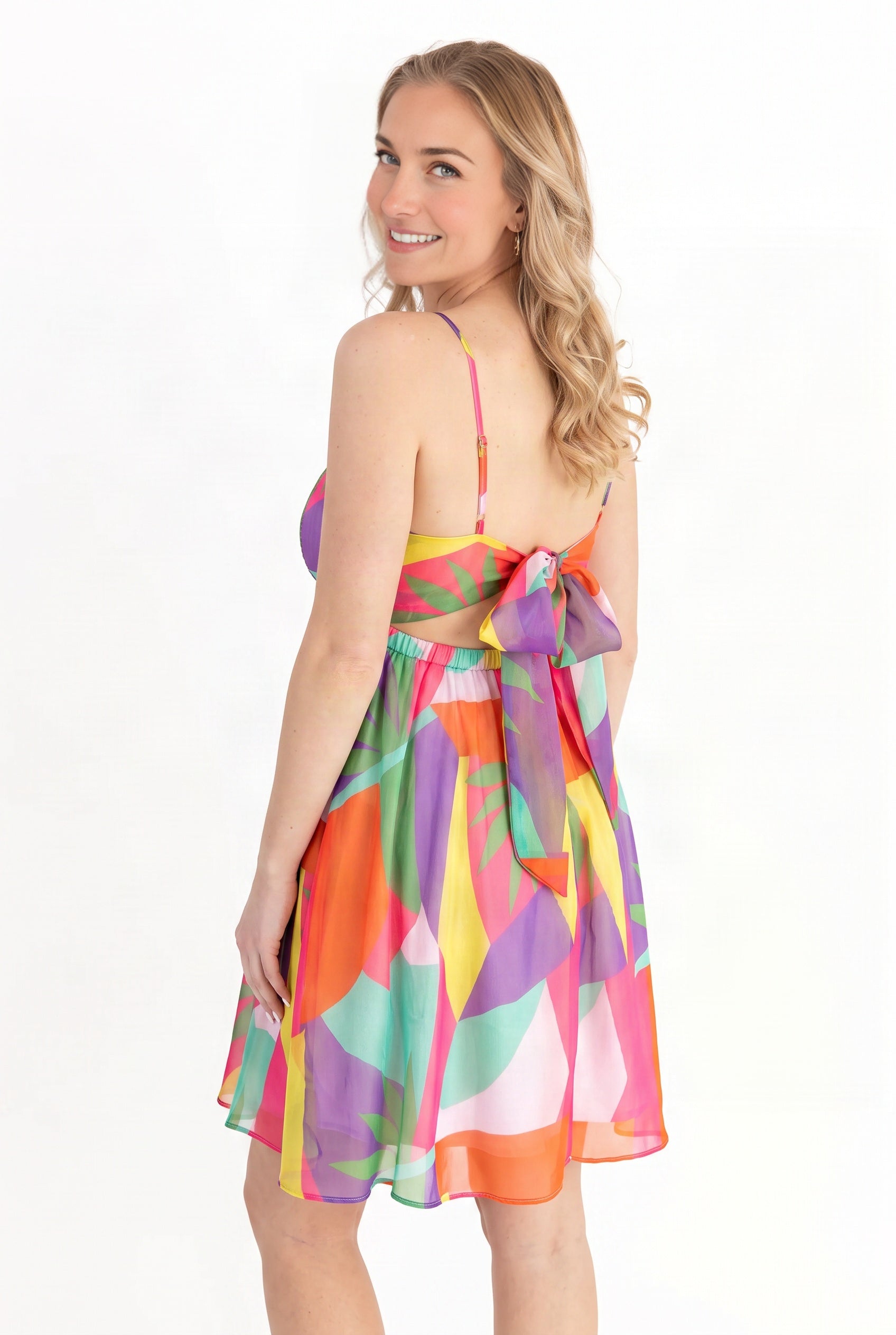 Back of the Shore-ly Yours Tropical Mini Dress showing the open back and tied sash bow.
