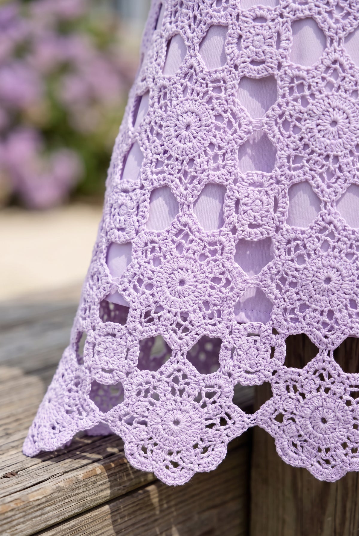 Close detail of the lavender floral crochet, tonal lining edge and openwork scalloped hem.