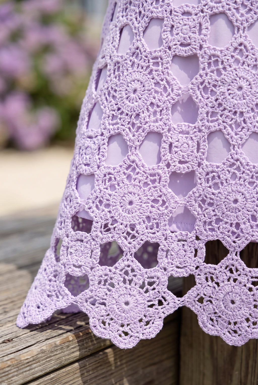 Close detail of the lavender floral crochet, tonal lining edge and openwork scalloped hem.
