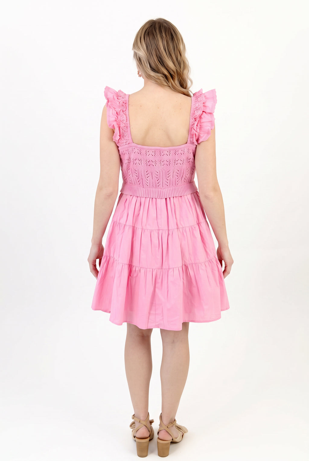 Back fit of the pink crochet dress in Small, showing the low square back and full tiered skirt.