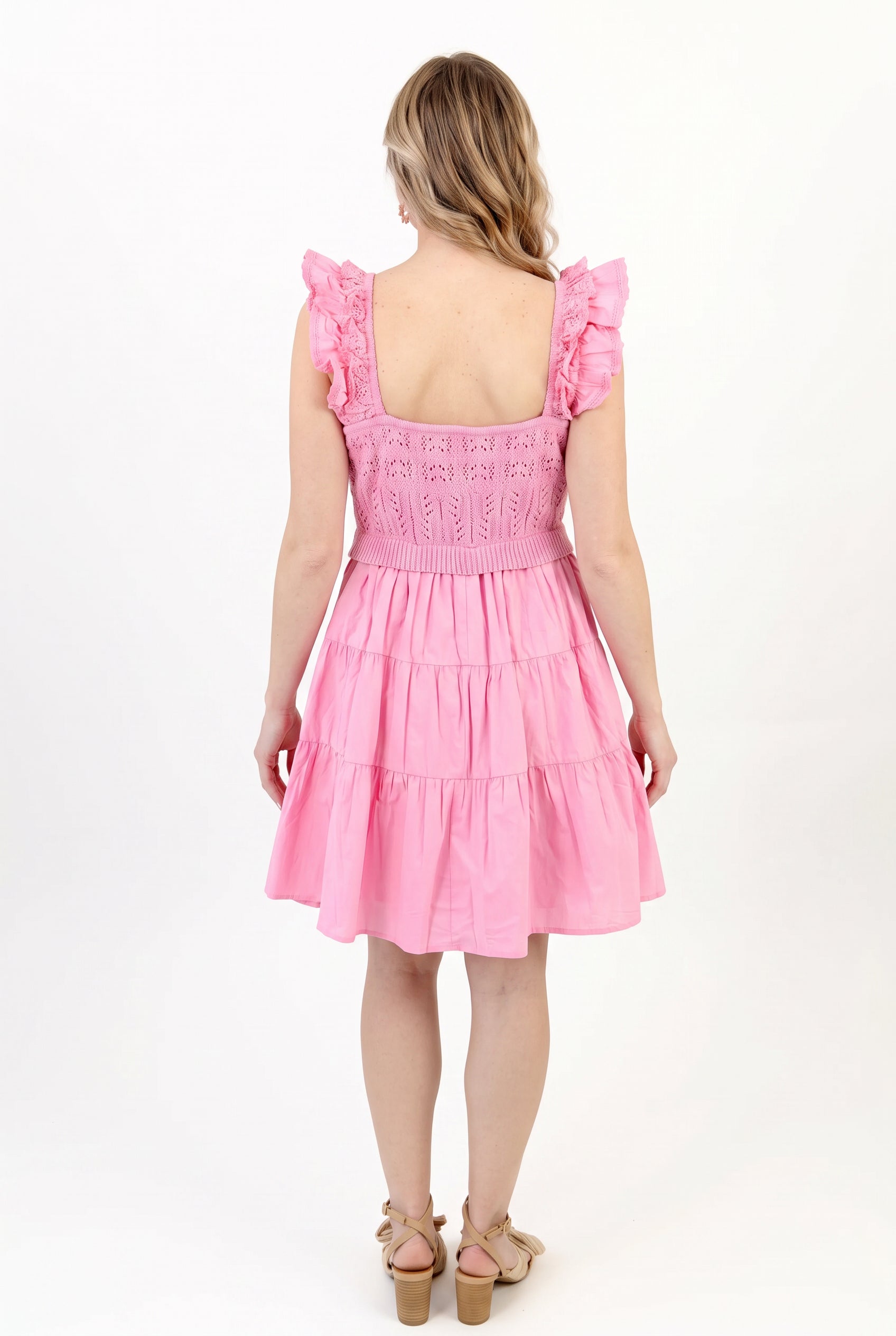 Back fit of the pink crochet dress in Small, showing the low square back and full tiered skirt.