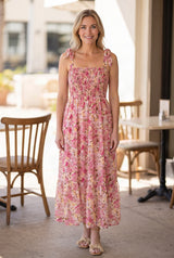 Enchanted Moments Floral Smocked Maxi Dress in Small shown full length on a sunny patio.